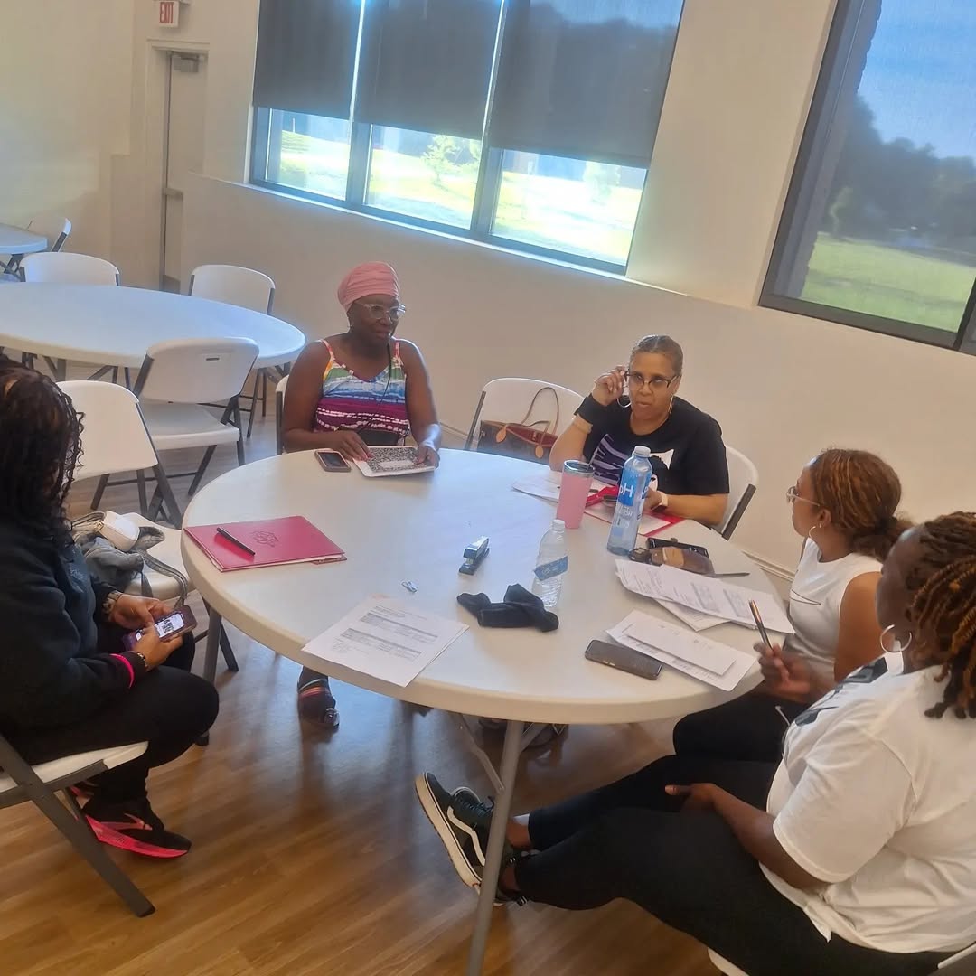 Group gathered around a table with papers